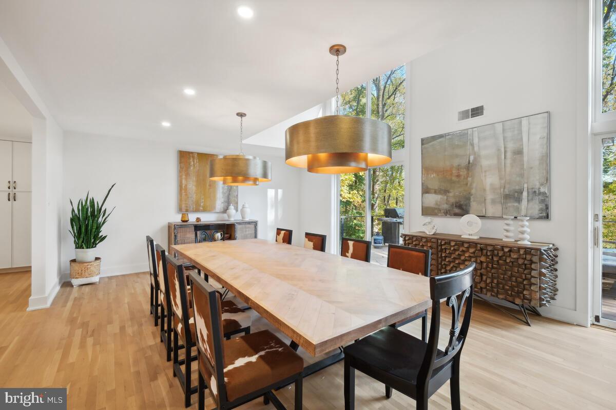 11900 Viewcrest Terrace Silver Spring, MD 20902 - Photo 19 of 69 a view of a dining room and livingroom with furniture wooden floor a chandelier