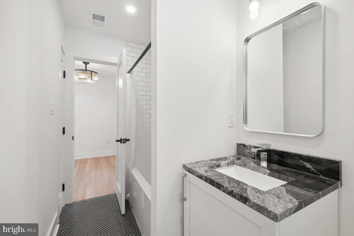 11900 Viewcrest Terrace Silver Spring, MD 20902 - Photo 45 of 69 a bathroom with a granite countertop sink and a mirror