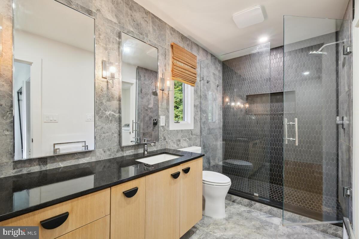 11900 Viewcrest Terrace Silver Spring, MD 20902 - Photo 46 of 69 a bathroom with a sink a toilet a mirror and shower