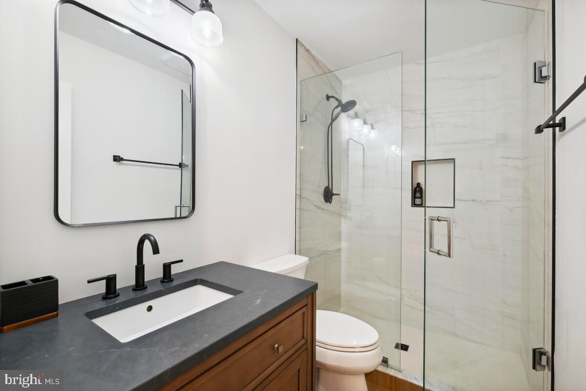 11900 Viewcrest Terrace Silver Spring, MD 20902 - Photo 56 of 69 a bathroom with a sink toilet and shower