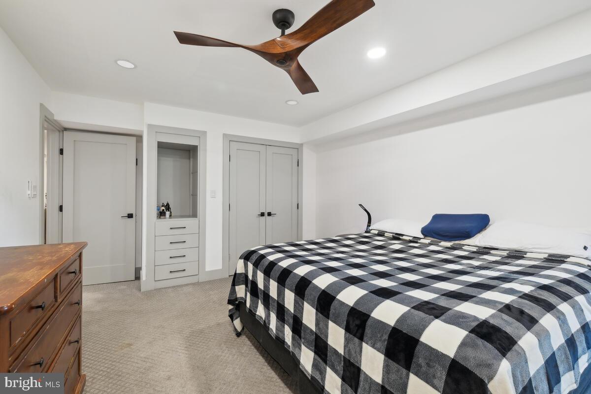 11900 Viewcrest Terrace Silver Spring, MD 20902 - Photo 60 of 69 a bedroom with a large bed and a chandelier