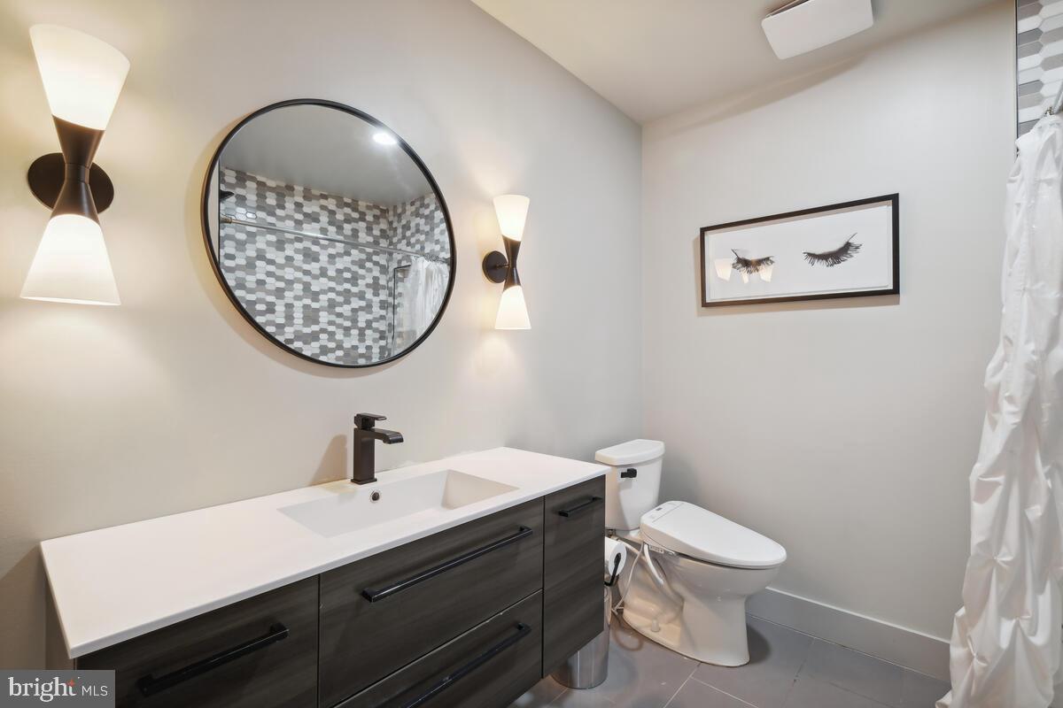 11900 Viewcrest Terrace Silver Spring, MD 20902 - Photo 63 of 69 a bathroom with a toilet a sink and mirror