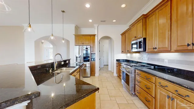 a kitchen with a refrigerator and a stove top oven