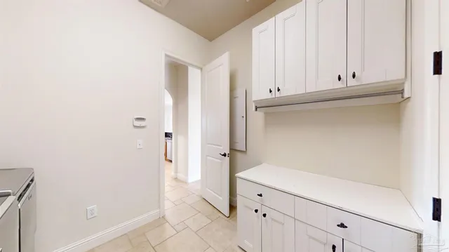 a bathroom with a granite countertop toilet sink and mirror