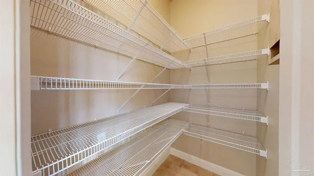 an empty room with closet and windows