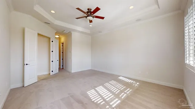 a spacious bedroom with a bed and a chandelier