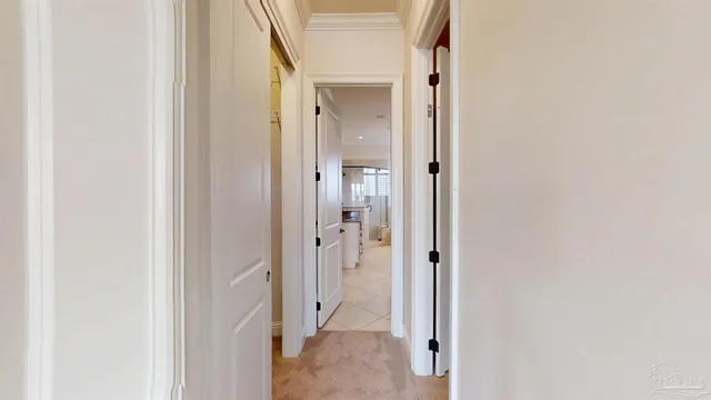 an empty room with windows and chandelier fan