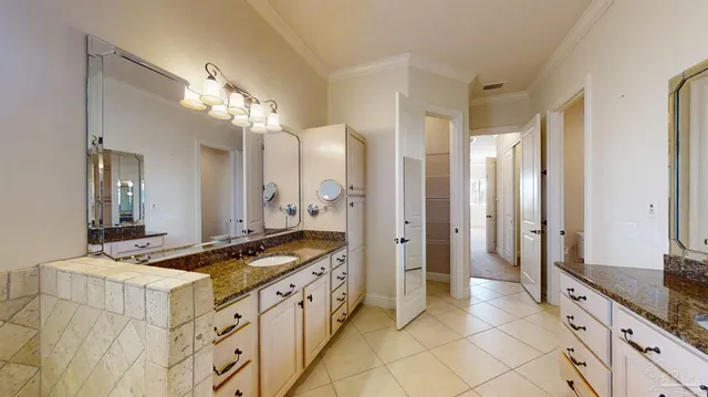 a living room with couches and dining table with dishwasher kitchen view