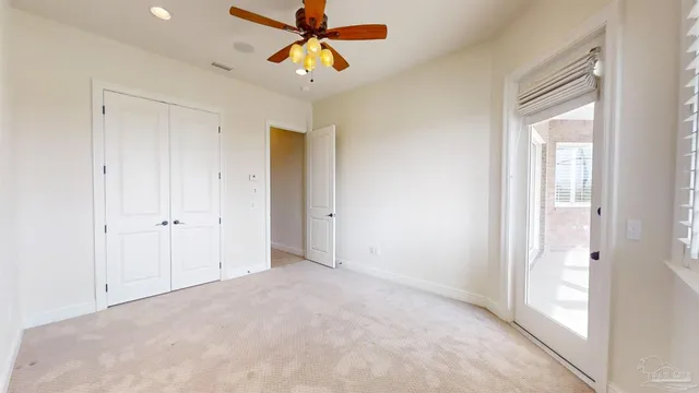 an aerial view of a city with lots of residential buildings ocean and mountain view in back