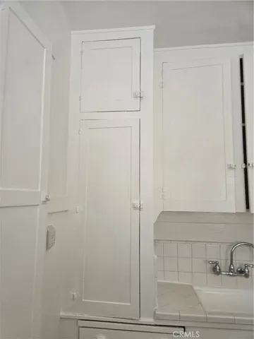 a view of a livingroom with wooden floor and staircase