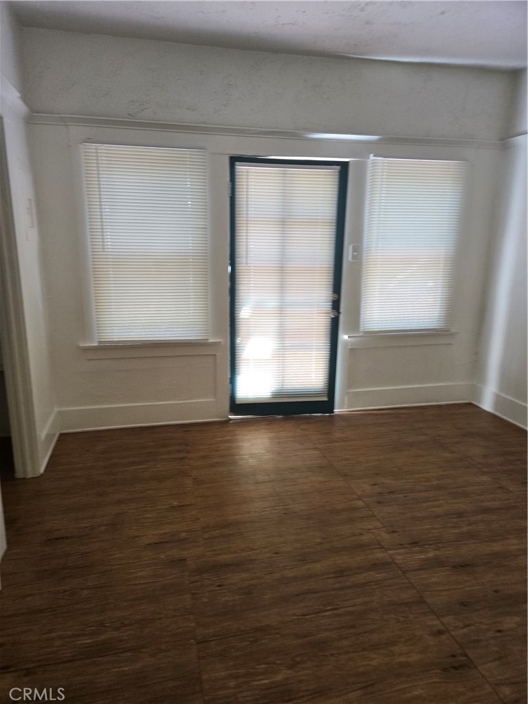 942 2nd Street, Unit 10 Long Beach, CA 90802 - Photo 17 of 28 a view of an empty room with wooden floor and a window