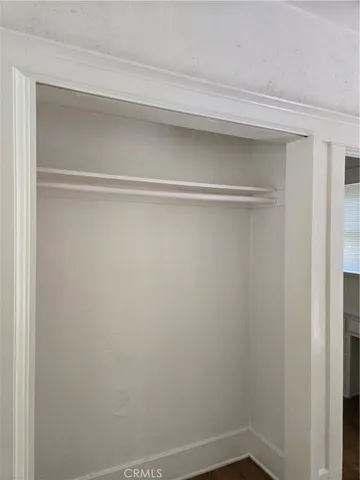 a view of a small space with wooden floor and a window