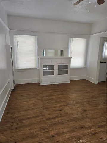 a view of a refrigerator in kitchen and wooden floor