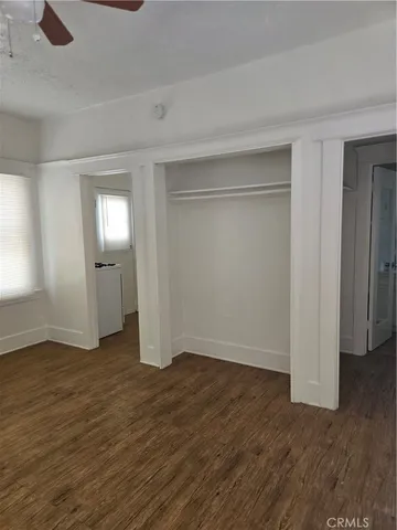 a view of a room with wooden floor and a window