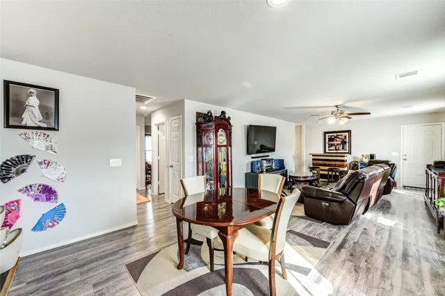 a bedroom with a bed and a flat tv screen on the dresser