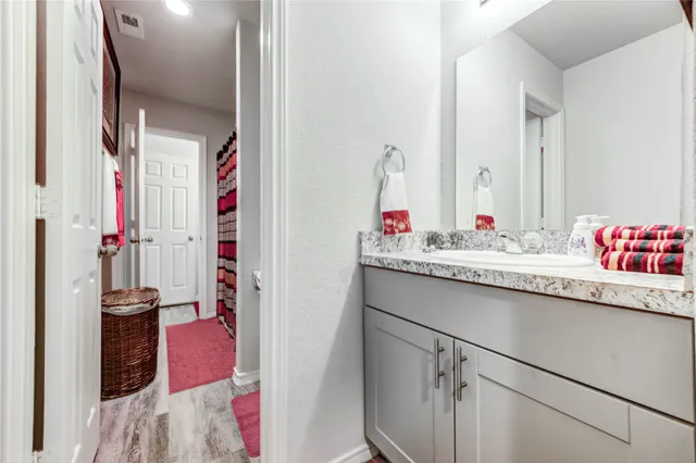 a front view of a house with a garden and lake view