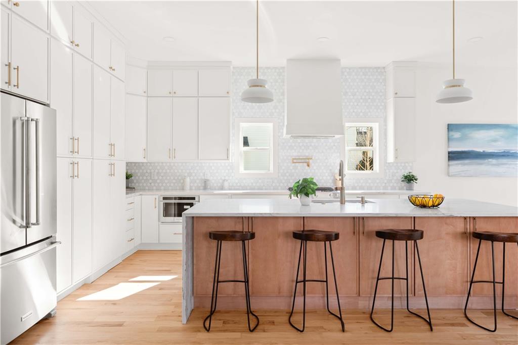 286 Sisson Avenue Northeast Atlanta, GA 30317 - Photo 3 of 56 a kitchen with granite countertop white cabinets and chairs