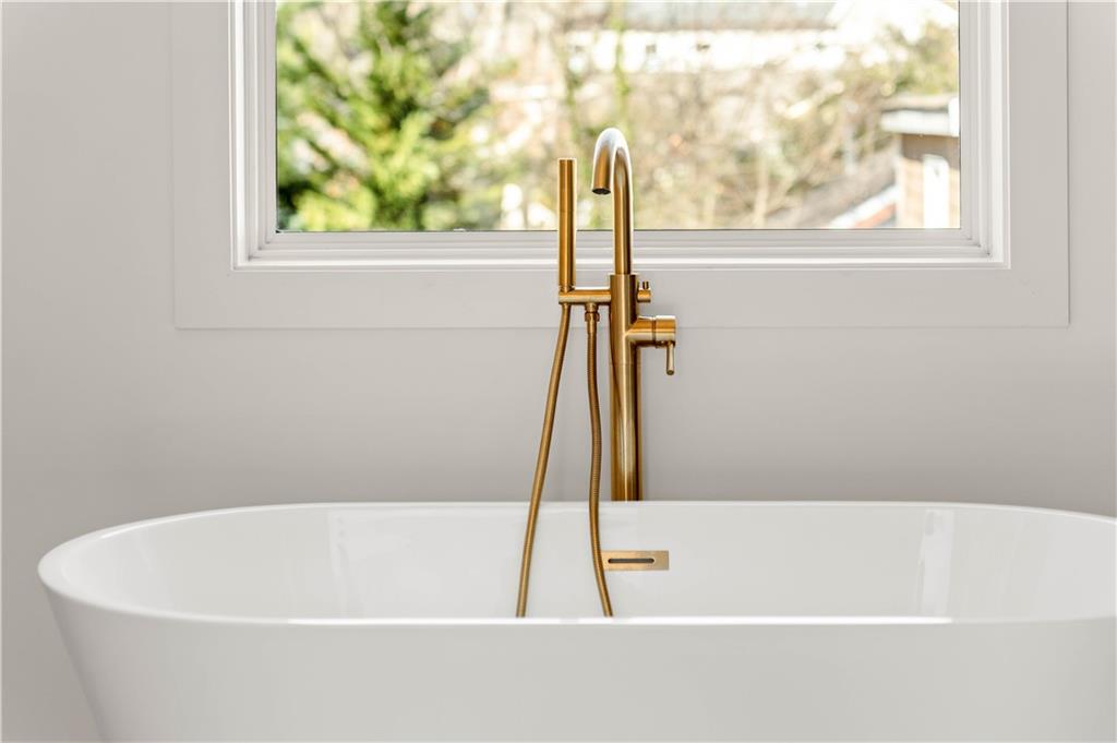 286 Sisson Avenue Northeast Atlanta, GA 30317 - Photo 37 of 56 a white bath tub sitting next to a window