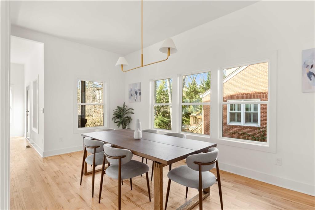 286 Sisson Avenue Northeast Atlanta, GA 30317 - Photo 10 of 56 a view of a dining room with furniture window and wooden floor