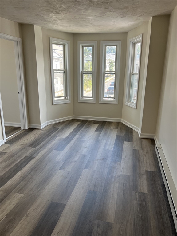 12 Aspen Street Ware, MA 01082 - Photo 11 of 17 a view of an empty room with wooden floor and a window