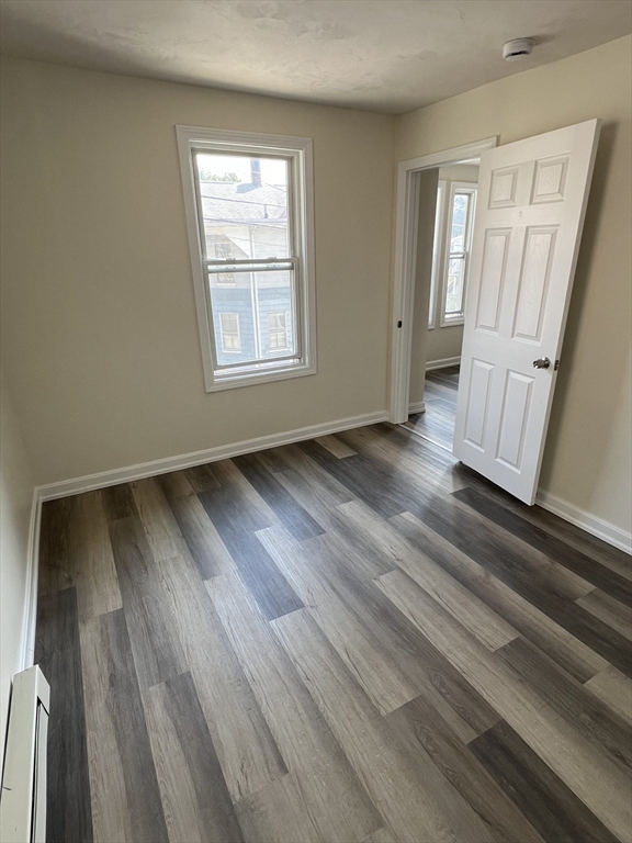 12 Aspen Street Ware, MA 01082 - Photo 12 of 17 an empty room with wooden floor and windows