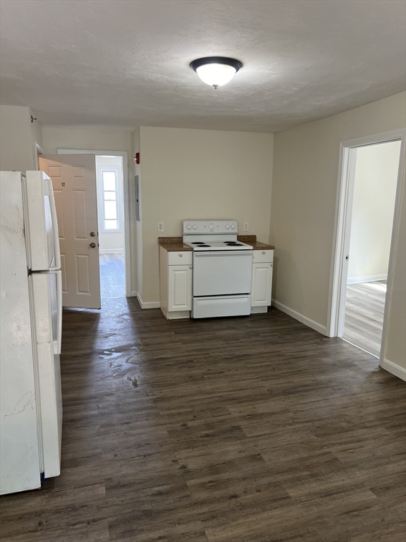 12 Aspen Street Ware, MA 01082 - Photo 2 of 17 a kitchen with stainless steel appliances a refrigerator and a wooden floor