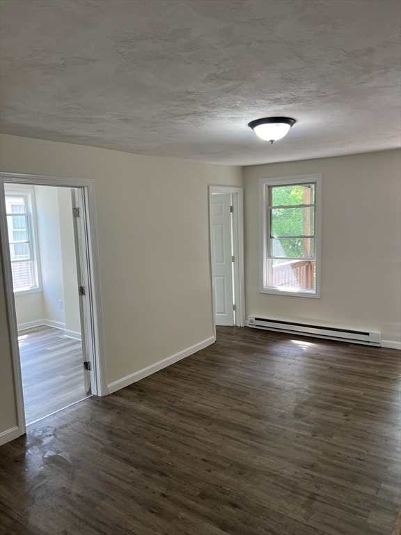 12 Aspen Street Ware, MA 01082 - Photo 6 of 17 an empty room with wooden floor and windows