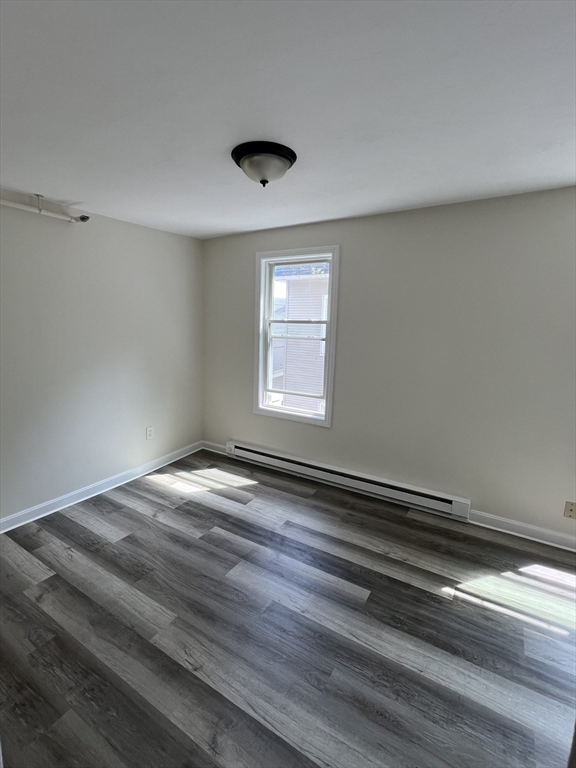 12 Aspen Street Ware, MA 01082 - Photo 7 of 17 a view of empty room with window and wooden floor