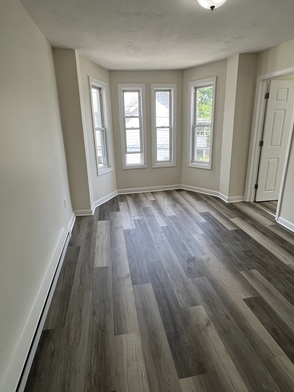 12 Aspen Street Ware, MA 01082 - Photo 9 of 17 an empty room with wooden floor and windows