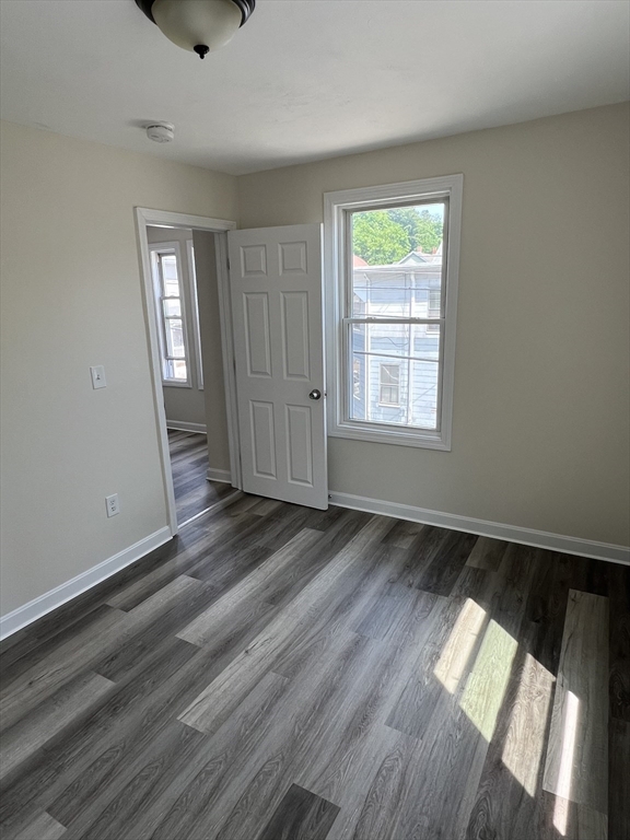 12 Aspen Street Ware, MA 01082 - Photo 10 of 17 an empty room with wooden floor and windows