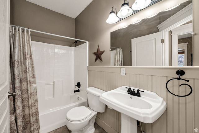 288 525 South Providence, UT 84332 - Photo 21 of 71 Bathroom featuring a white pedestal sink with black fixtures, a white toilet, and a white tub/shower combination with black fixtures