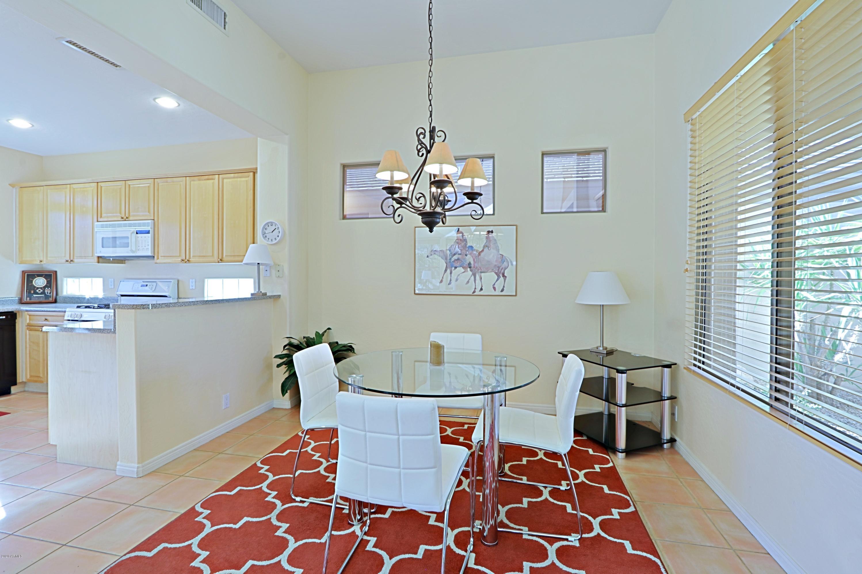 6803 East Eagle Feather Road Scottsdale, AZ 85266 - Photo 8 of 67 a dining room dining table chairs and a chandelier