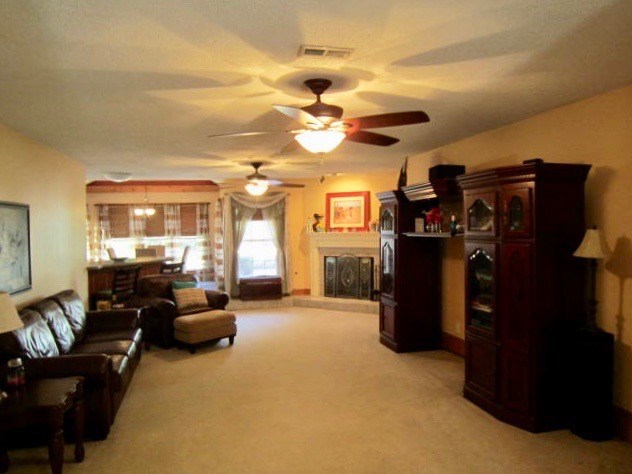 1450 Johnson Road Macon, GA 31220 - Photo 3 of 23 a living room with furniture cabinets and a chandelier