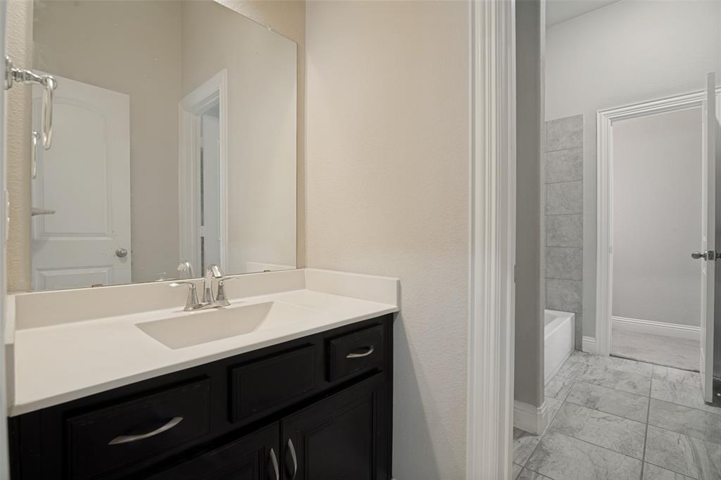 2802 Merlot Circle Rowlett, TX 75088 - Photo 31 of 40 a bathroom with a sink and a mirror