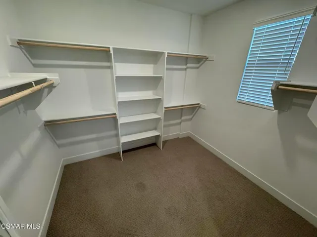 a view of room and closet with empty racks