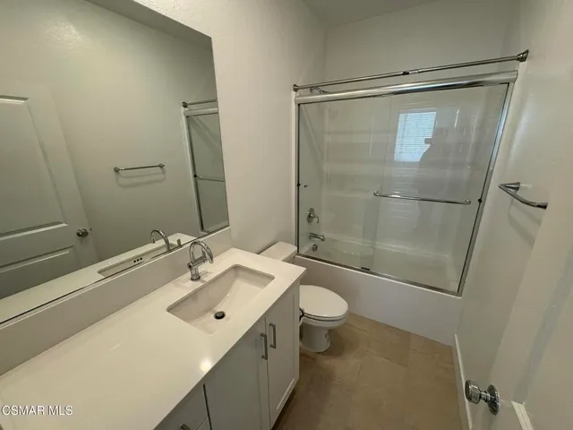 a bathroom with a sink mirror vanity and toilet