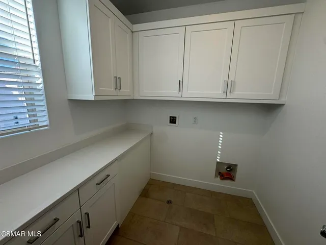 a kitchen with white cabinets and a sink