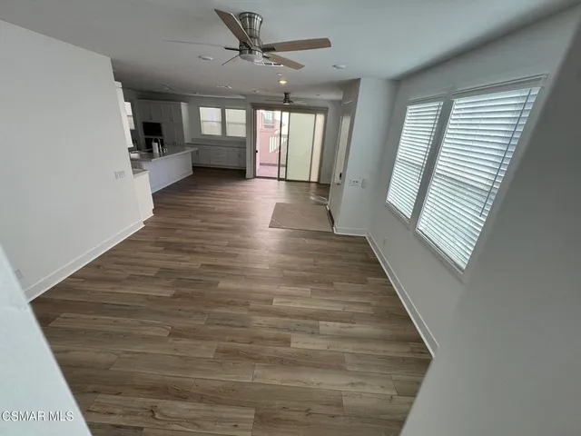a view of hallway with stairs and wooden floor