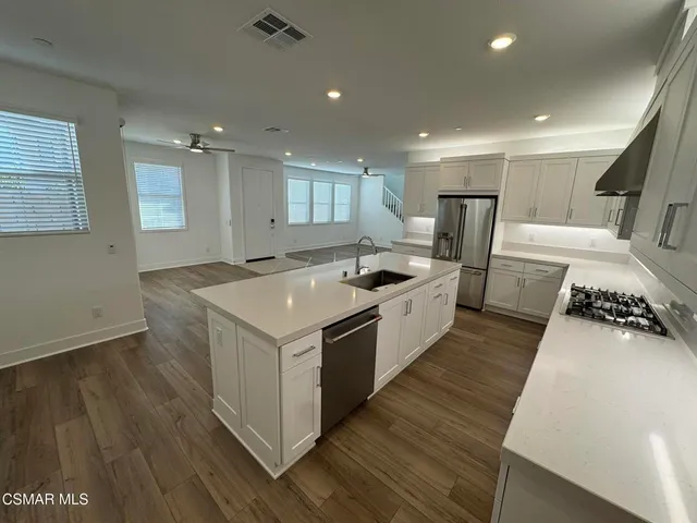 a kitchen with a stove and a refrigerator