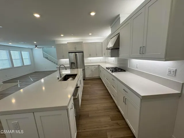 a kitchen with a sink a counter top space and cabinets