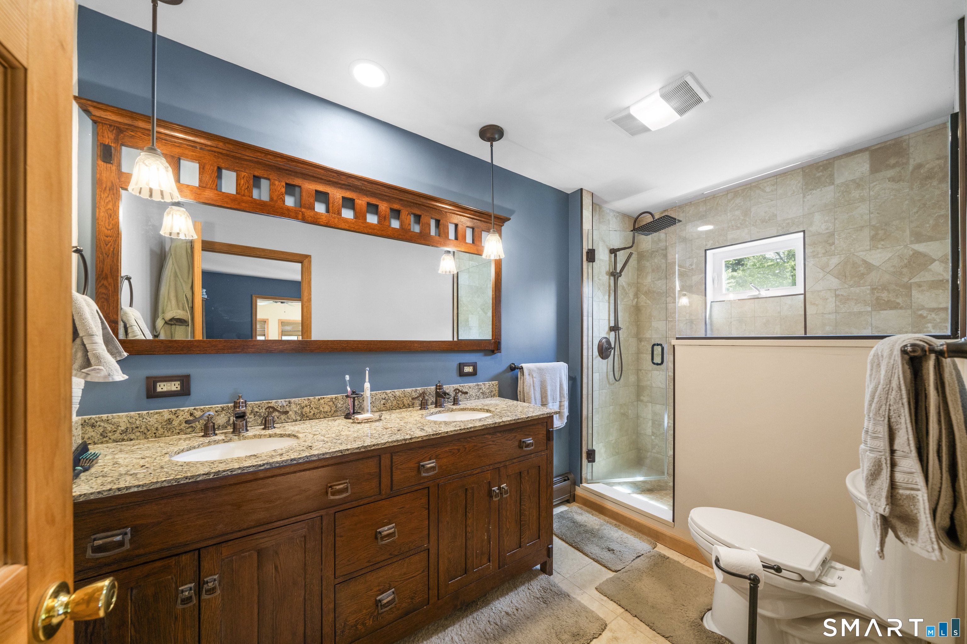 80 Holmes Road Goshen, CT 06756 - Photo 29 of 40 a bathroom with a granite countertop toilet sink and mirror