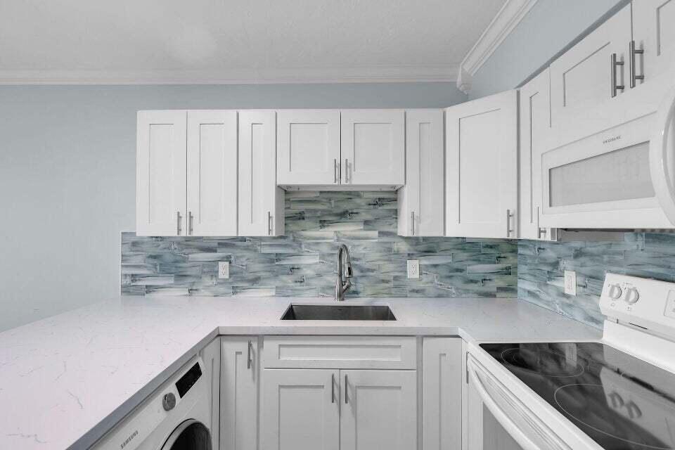 300 Duck Key Drive, Unit 9 Duck Key, FL 33050 - Photo 5 of 22 a kitchen with a sink cabinets and stainless steel appliances