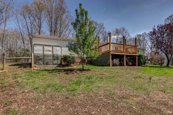 a view of balcony with wooden floor and fence