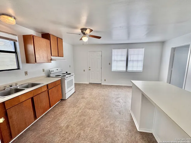 a kitchen with a stove a sink and a refrigerator