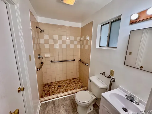 a bathroom with a sink toilet and shower