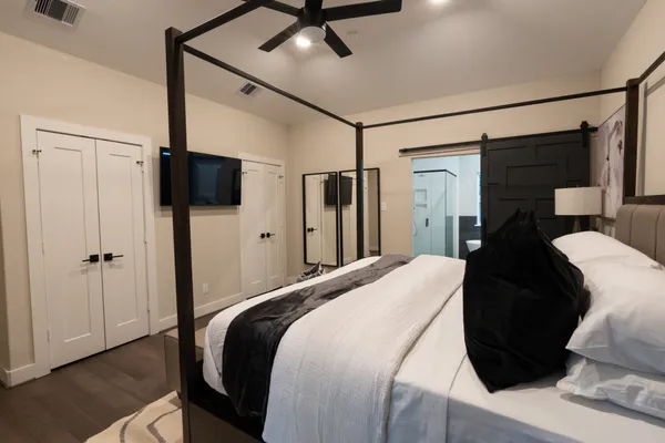 a bedroom with a bed and a flat tv screen