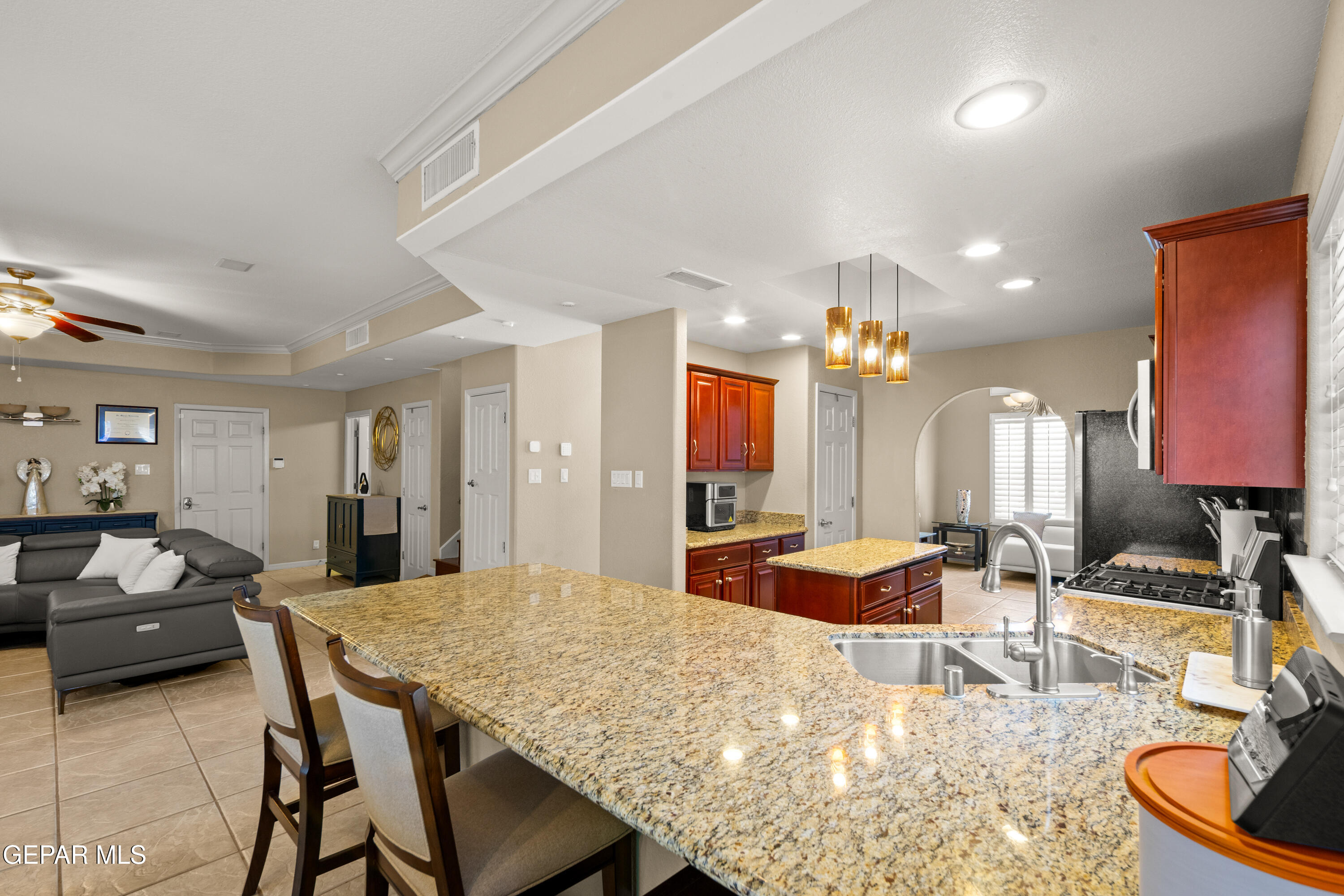 6705 Pearl Ridge Drive El Paso, TX 79912 - Photo 19 of 58 a living room with furniture a chandelier