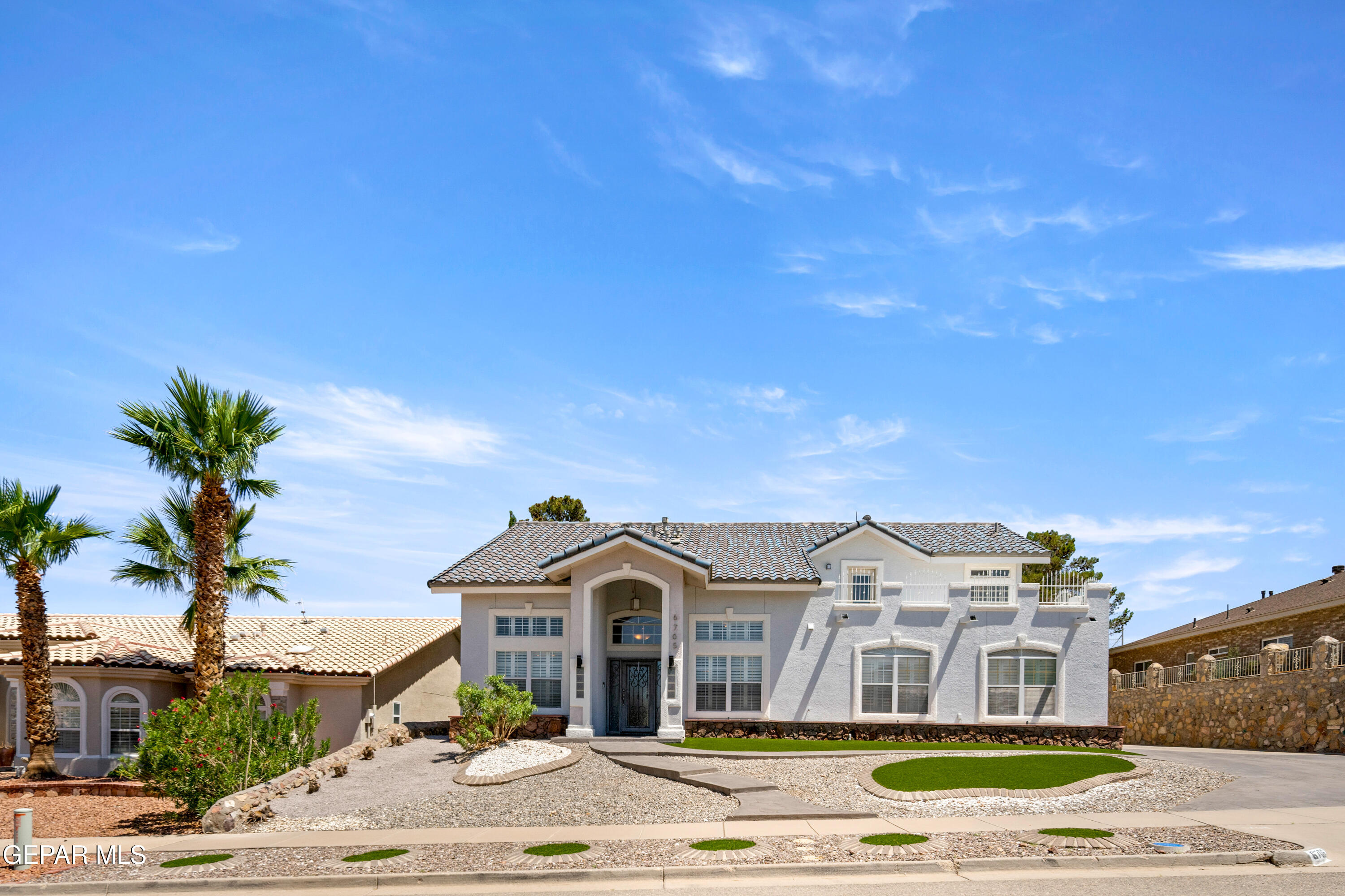 6705 Pearl Ridge Drive El Paso, TX 79912 - Photo 2 of 58 a front view of a house with a garden and yard