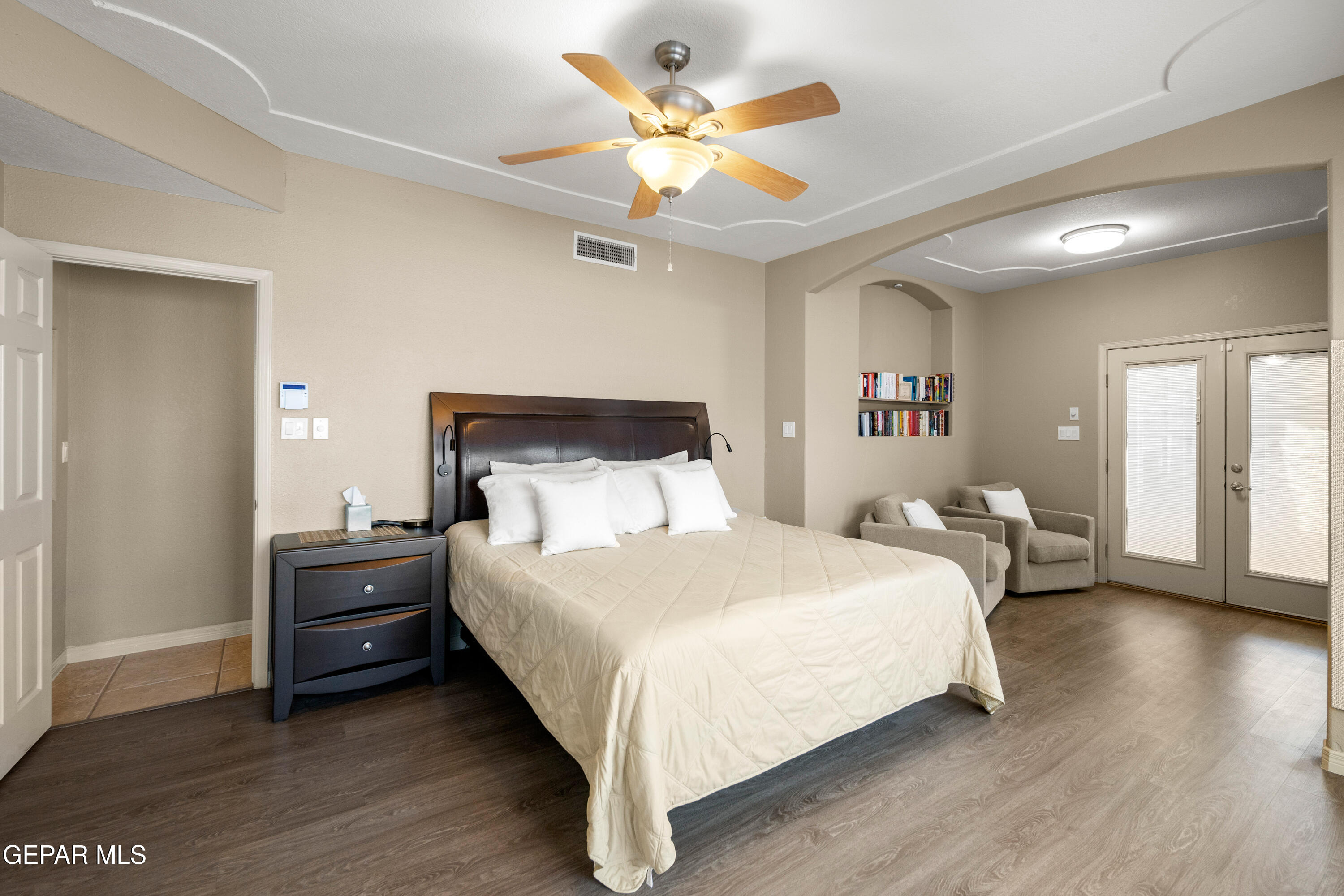 6705 Pearl Ridge Drive El Paso, TX 79912 - Photo 22 of 58 a bedroom with a bed and a chandelier