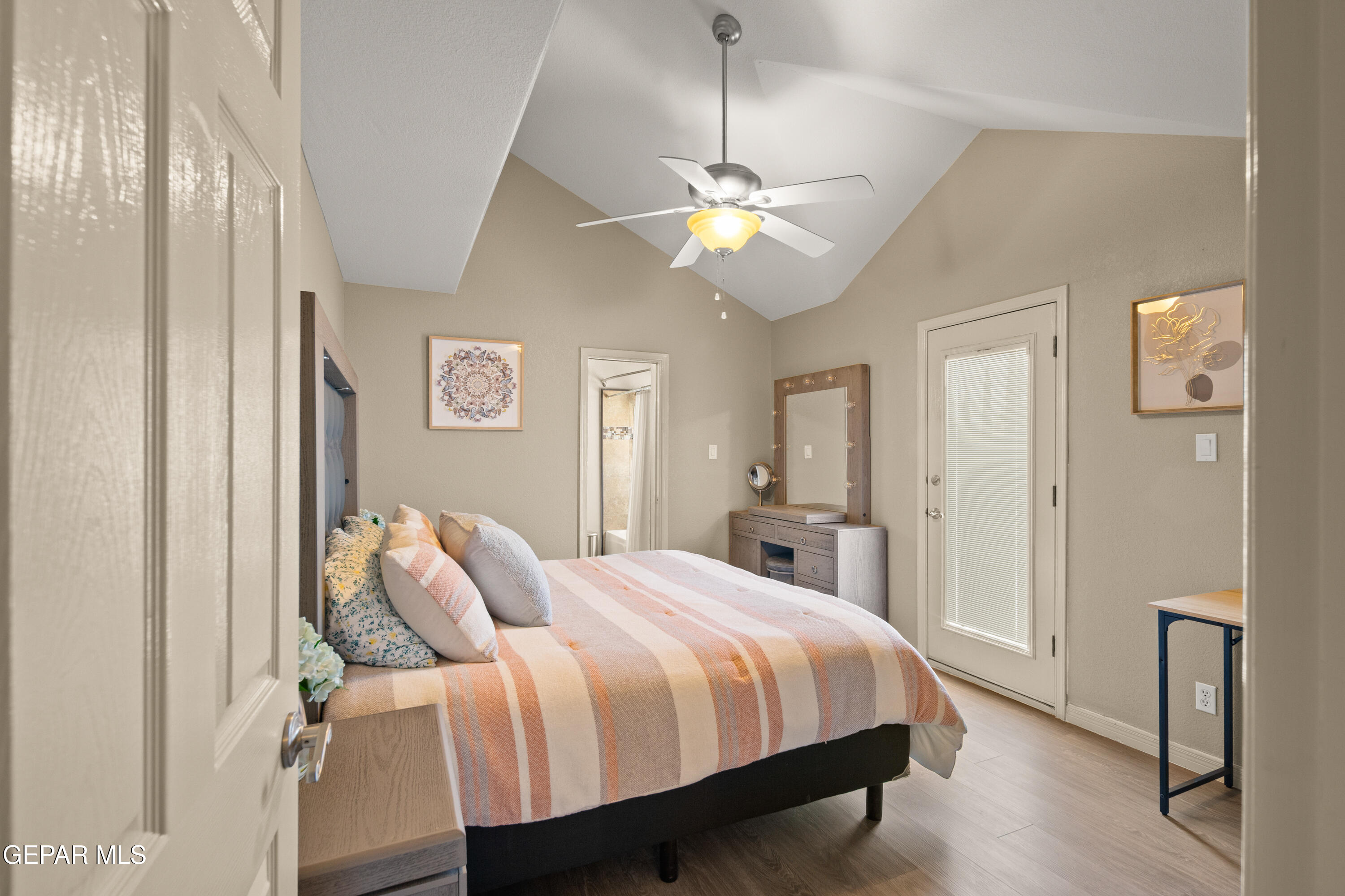 6705 Pearl Ridge Drive El Paso, TX 79912 - Photo 39 of 58 a spacious bedroom with a bed and a chandelier